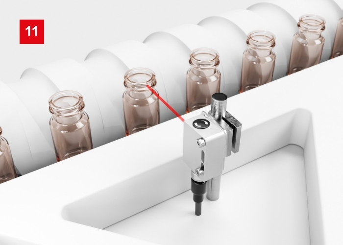 Lichttaster mit V-Optik HT55V für präzise Detektionspunkte vor Hintergrund mit Förderschnecke
